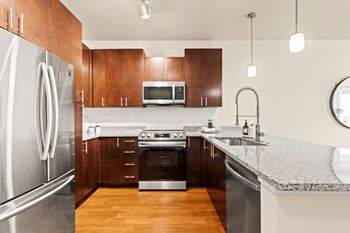 a kitchen with stainless steel appliances and granite counter tops